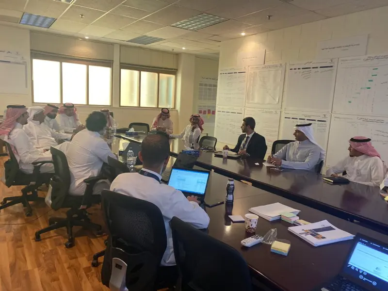 Program war-room session with planning boards on the walls