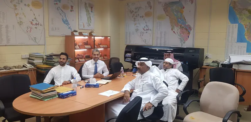Working session with Saudi Geological Survey leaders in a map-lined meeting room